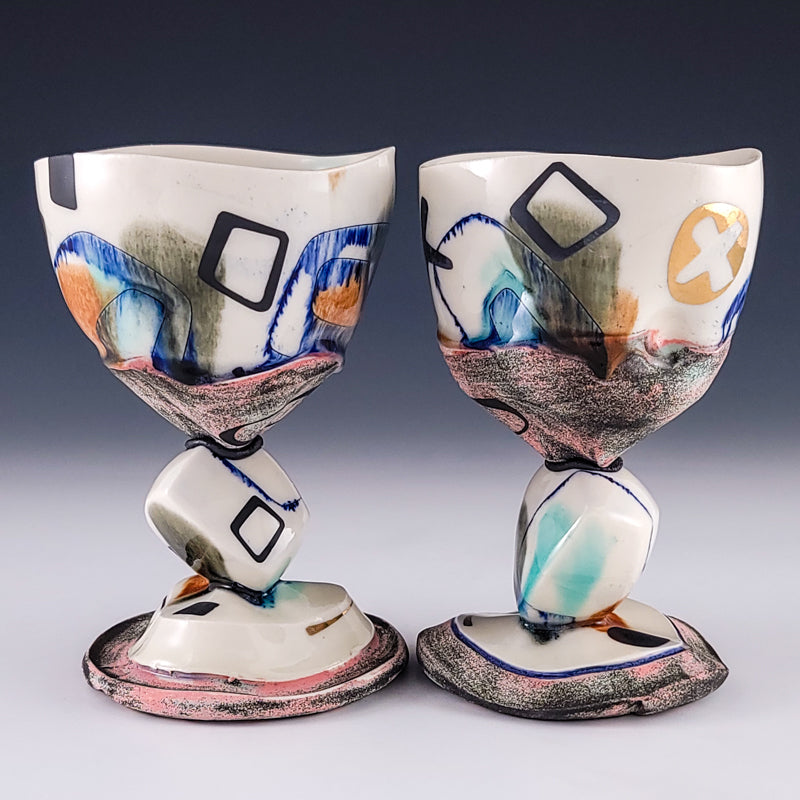 Pair of ceramic goblets with geometric stems and gold accents