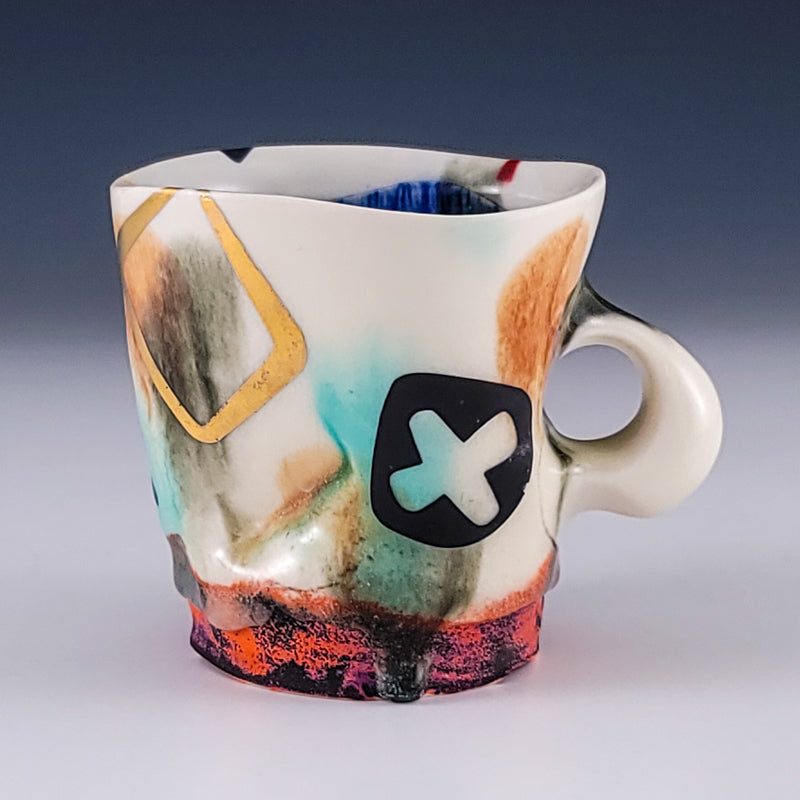 Ceramic mug with teal washes, gold square, and textured foot
