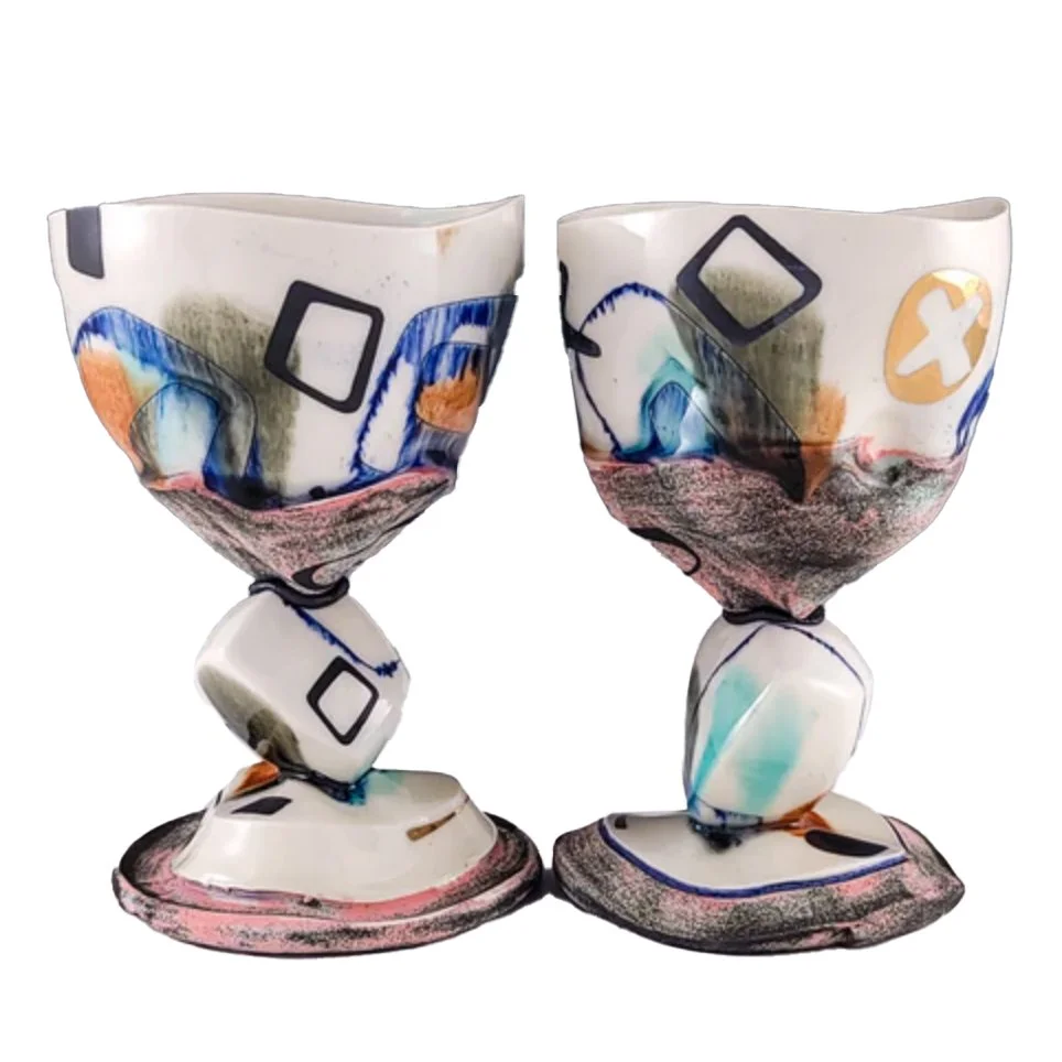 Pair of sculptural ceramic chalices against a white ground